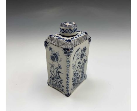 A Dutch delft blue and white tea caddy and cover, circa 1800, of tall rectangular section, painted with Chinoiserie panels of