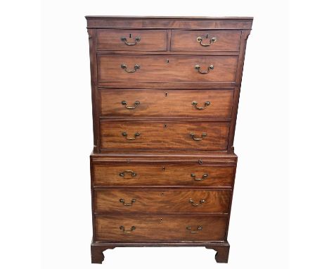 A George III mahogany chest on chest, the upper part with plain cornice above two short and three long drawers within fluted 