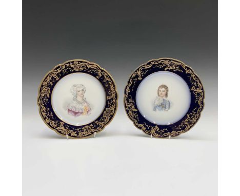 A pair of Sevres porcelain plates, each with a signed portrait within royal blue and gilt borders, printed Chateau des Tuiler