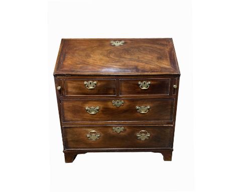 A George III mahogany bureau, with a fall front and fitted interior above two short and two long drawers, on bracket feet, he