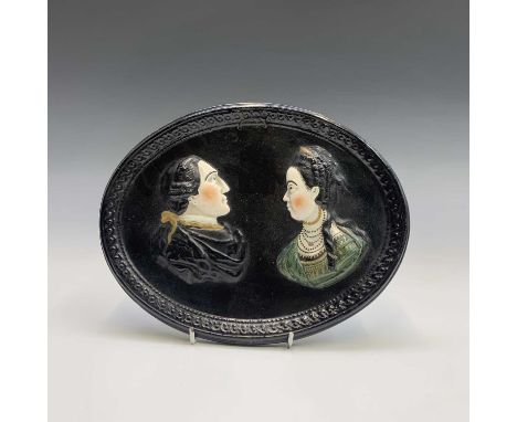 Of American Interest. An oval pearlware plaque, circa 1800, moulded and overpainted with the figures of George Washington, fi