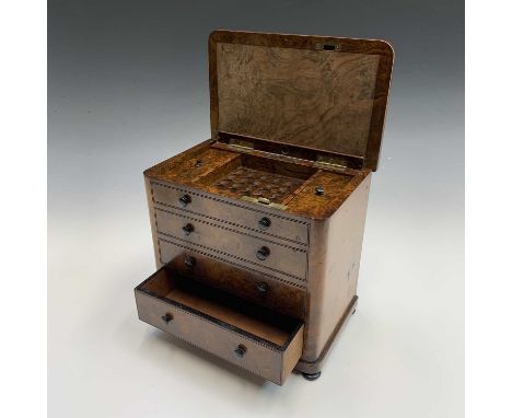 A mid Victorian burr walnut cigar cabinet fashioned as a chest with four long drawers, the hinged top released by pushing the