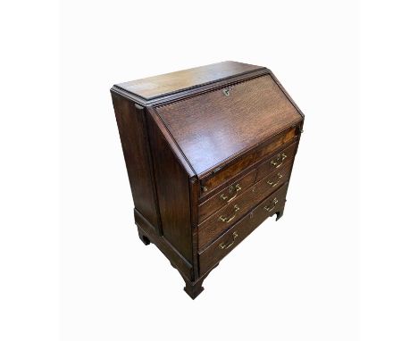 A George II oak bureau, the fall front opening to reveal a fitted interior above two short and two long drawers on bracket fe