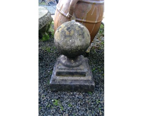 A cast stone gate post finial of spherical form on stepped base. Height 44cm.