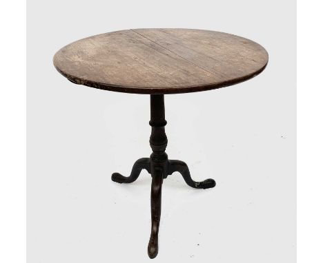A George III mahogany tripod table, the circular snap top on a turned baluster stem and downswept legs with pad feet, height 