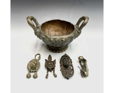 A 19th century heavy brass bowl, with twin handles and deep relief foliate cast decoration on a lotus cast foot, total width 