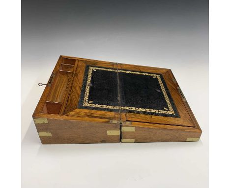 A Victorian walnut and brass bound writing slope, with gilt tooled leather writing surface and fitted with pen holder, compar
