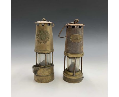 A brass miner's lamp, by Protector Lamp &amp; Lighting Co Ltd, Eccles, height 26cm, together with another miner's lamp (2).