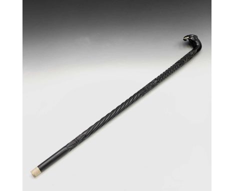 An Indian ebony walking stick, circa 1900, the finial carved as the head of an elephant, the shaft carved with foliage, and s