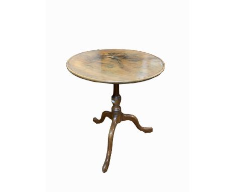 A George III mahogany tripod table, the dished top on a baluster stem and downswept legs, with pad feet, diameter of top 58cm