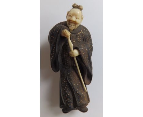 A 19thC Japanese wood & ivory netsuke figure of a sage holding a staff, gold painted details to gown, 3.2”