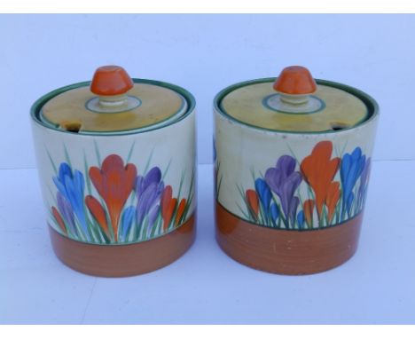 A Clarice Cliff Wilkinson's Pottery crocus pattern preserve jar together with a damaged example by Newport Pottery. (2)