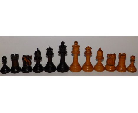 A carved wooden chess set, the kings 4” high.