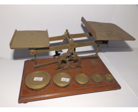 A set of postal scales with weights.