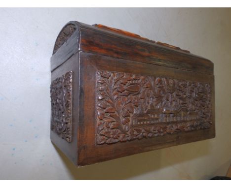 A carved wood Indian tea caddy with domed top.