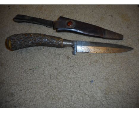 A German hunting knife with antler horn handle in leather sheath.