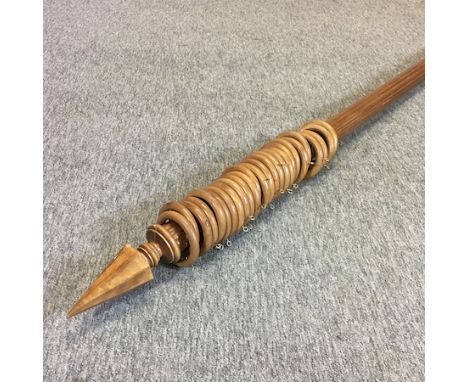 A fluted wooden curtain pole, carved in the form of an arrow, 260cm long