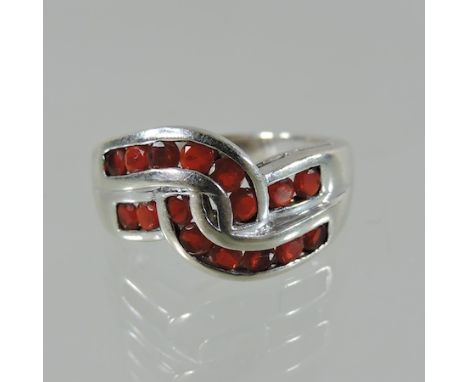 A white gold and ruby channel set ring, boxed, 