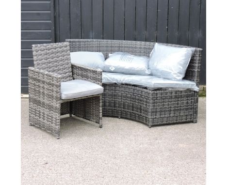 A grey rattan curved sofa, 180cm, together with a small armchair, with grey cushions