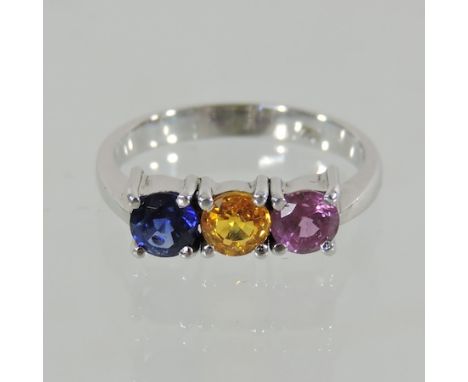 An 18 carat gold three colour sapphire ring