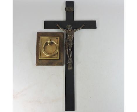 A cast metal figure of the crucifixion, 73 x 36cm, together with a brass door knocker mounted on an oak plaque, 22 x 17cm