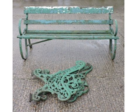 A Regency style strapwork garden bench, 153cm, together with a pair of green painted cast iron bench ends
