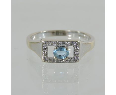 An 18 carat white gold topaz and diamond art deco style ring