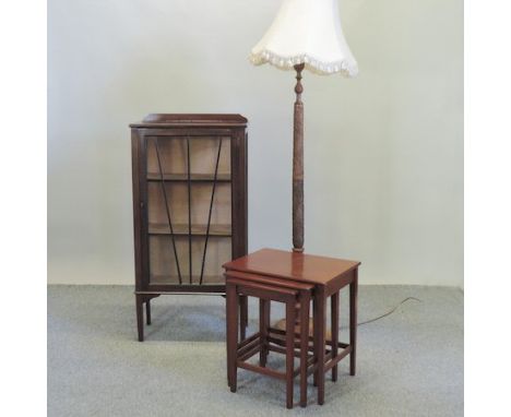 A 1920's display cabinet, together with a carved standard lamp and a nest of tables