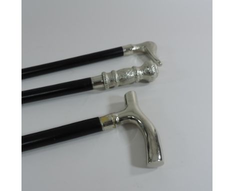 A modern walking stick, with a white metal handle, together with two others