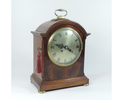 An early 20th century mahogany bracket clock, the silvered dial showing Roman numerals, 8 day movement, all standing on four 