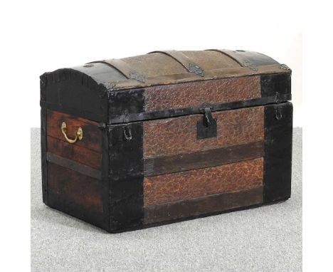 A dome top trunk, with embossed leather decoration, flanked by carrying handles80w x 44d x 53h cm