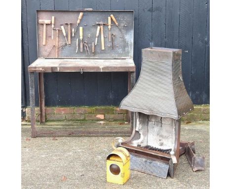 A metal folding workshop bench, together with a cast iron fireplace, 54cm wide and a road lantern