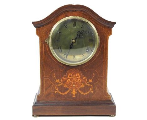 An Edwardian mahogany and inlaid mantel clock, with a brass dial, 35cm high