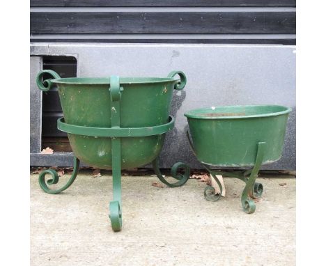 A green painted cast iron planter, on stand, 52cm diameter, together with another smaller (2)