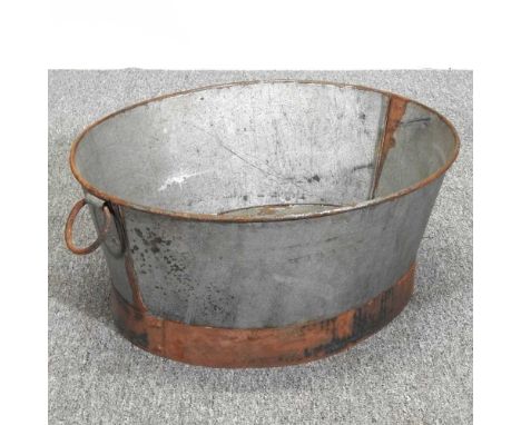 An oval galvanised planter 63cm x 54cm x 26cm.
