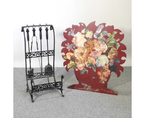 A fire screen, painted with coloured flowers, 81cm wide, together with a wrought iron companion set (2)