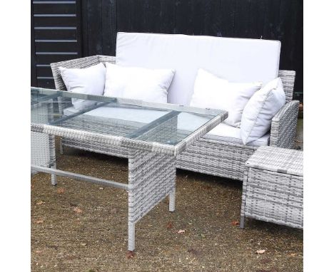A rattan garden sofa, with matched cushions, together with a matching dining table, with a glass top, and two stools (4)Sofa 