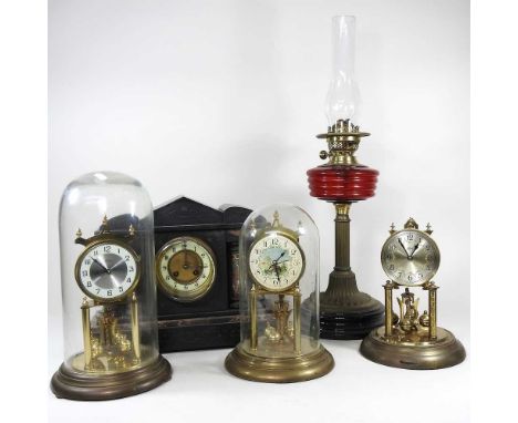 Three anniversary clocks, two with glass domes, highest 35cm overall, together with a black slate mantel clock and a brass oi