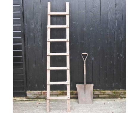 A wooden ladder, 220cm high, together with a vintage shovel