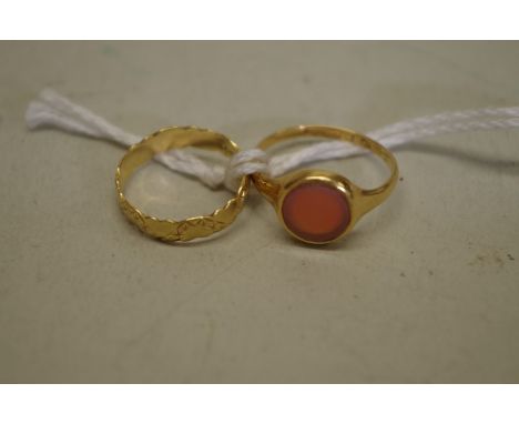 A carnelian gold signet ring,&nbsp;hallmarked 18ct; together with a childs gold band, also hallmarked 18ct, decorated hearts,