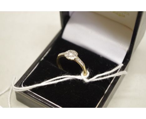 A diamond 'daisy' cluster gold ring, stamped 18ct, 2.6g total weight. 