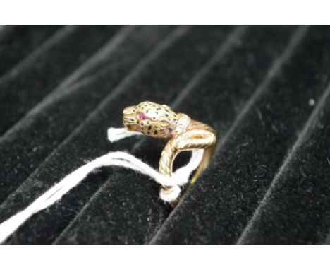 A yellow metal panther ring, decorated enamel spots set with ruby eyes and diamond collar, 7g total weight. 