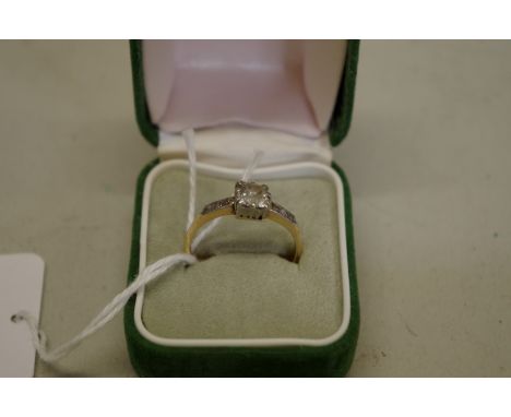 A cushion cut diamond gold ring,&nbsp;approximately 0.8ct, having diamond shoulders, stamped 18ct, 3.1g gross weight. 