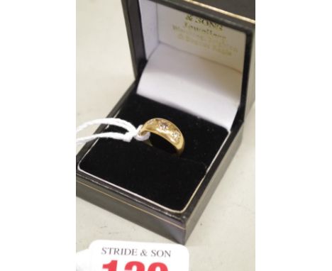 A childs three stone diamond gypsy set gold ring, hallmarked 18ct, 4g total weight. 