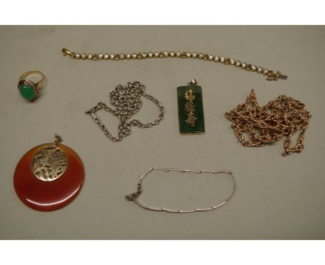 A green jade set gold ring, stamped 14k; together with two Oriental jade pendants; and four other items. (7) 