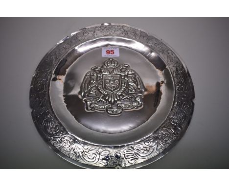 A Peruvian .900 embossed&nbsp;circular&nbsp;dish, decorated the city of Lima crest, 26.5cm diameter, 326g. 