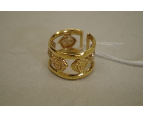 An unmarked yellow metal openwork lion mask ring. 