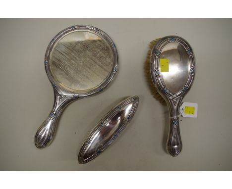 A Liberty &amp; Co silver and enamel Cymric&nbsp;three piece&nbsp;dressing set, by&nbsp;William Hair Haseler,&nbsp;Birmingham
