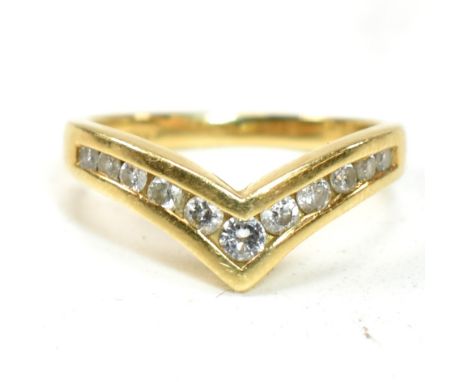 A hallmarked 18ct gold and diamond wishbone ring. The 18ct gold wishbone ring having eleven channel set graduating round cut 