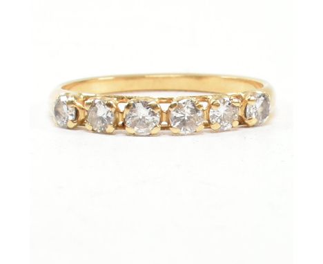 A gold and diamond six stone ring. The ring set with six round brilliant cut diamonds. Estimated total diamond weight 0.30ct.